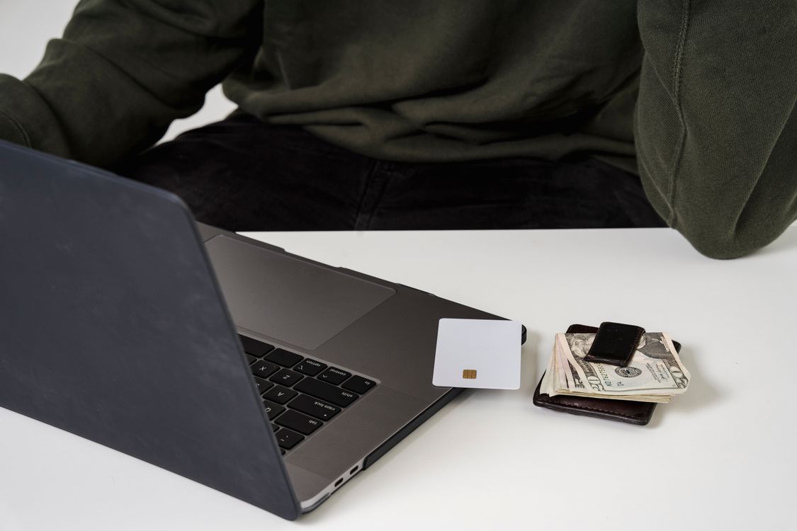 Customer shopping online with a laptop and payment card