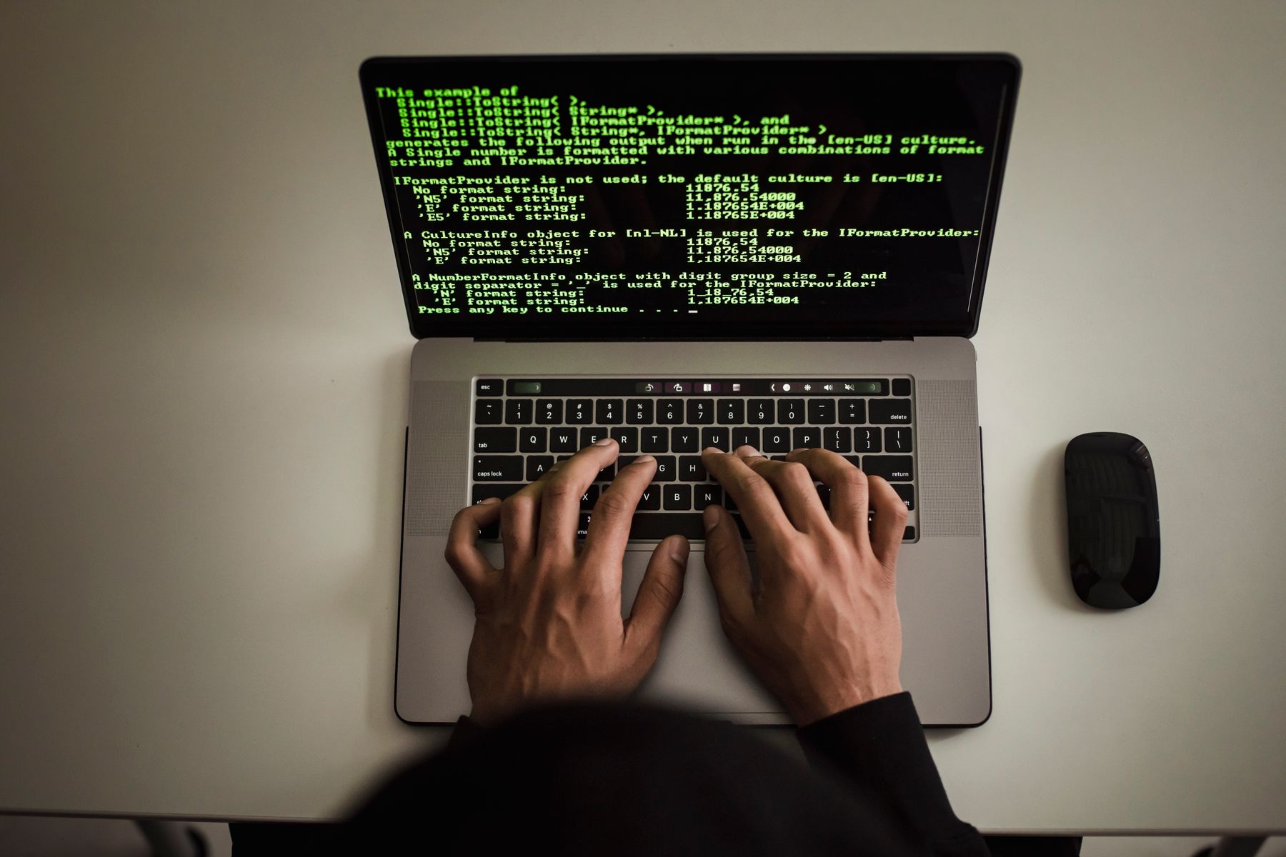Developer working with software code on a laptop